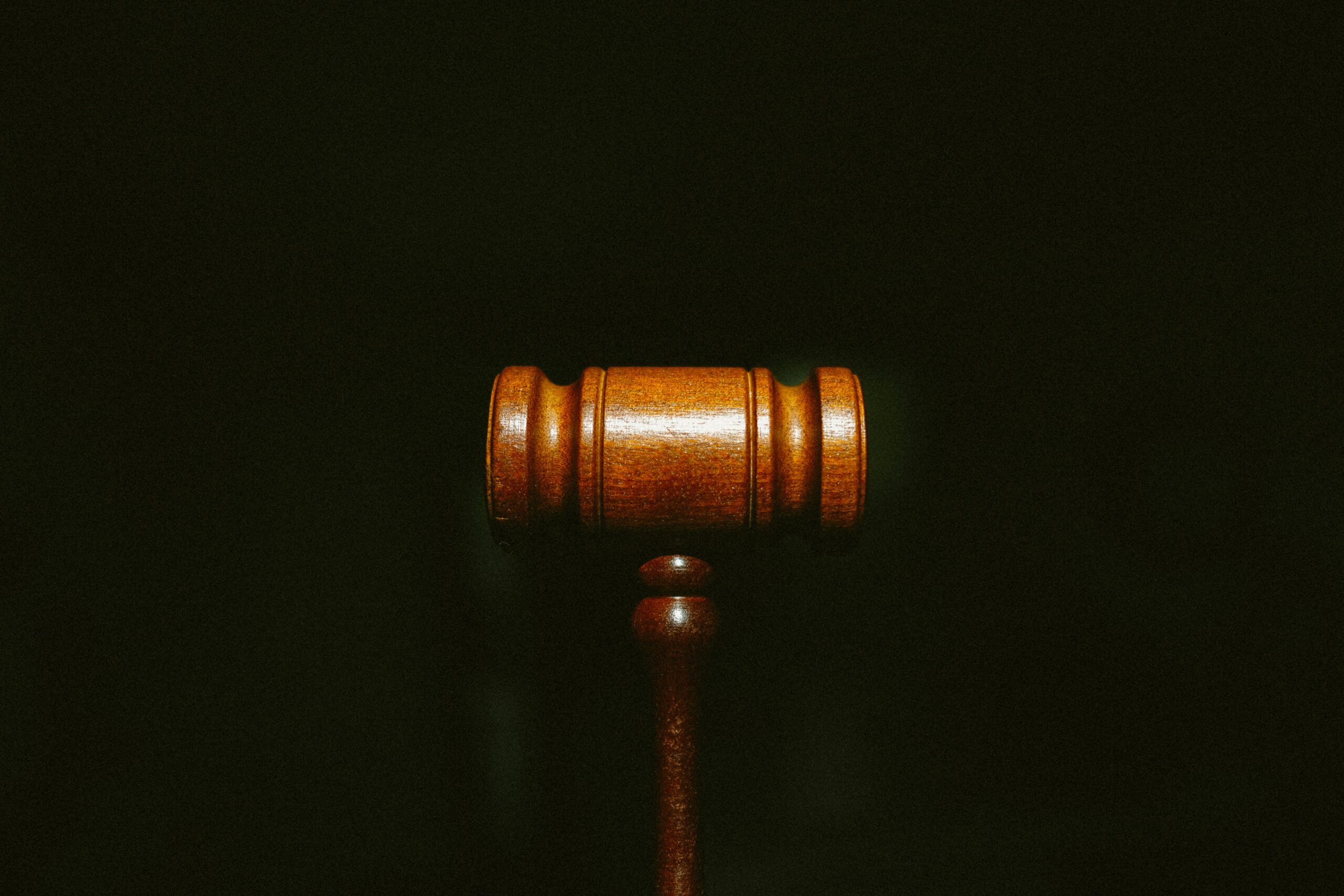 A gavel set on a black background